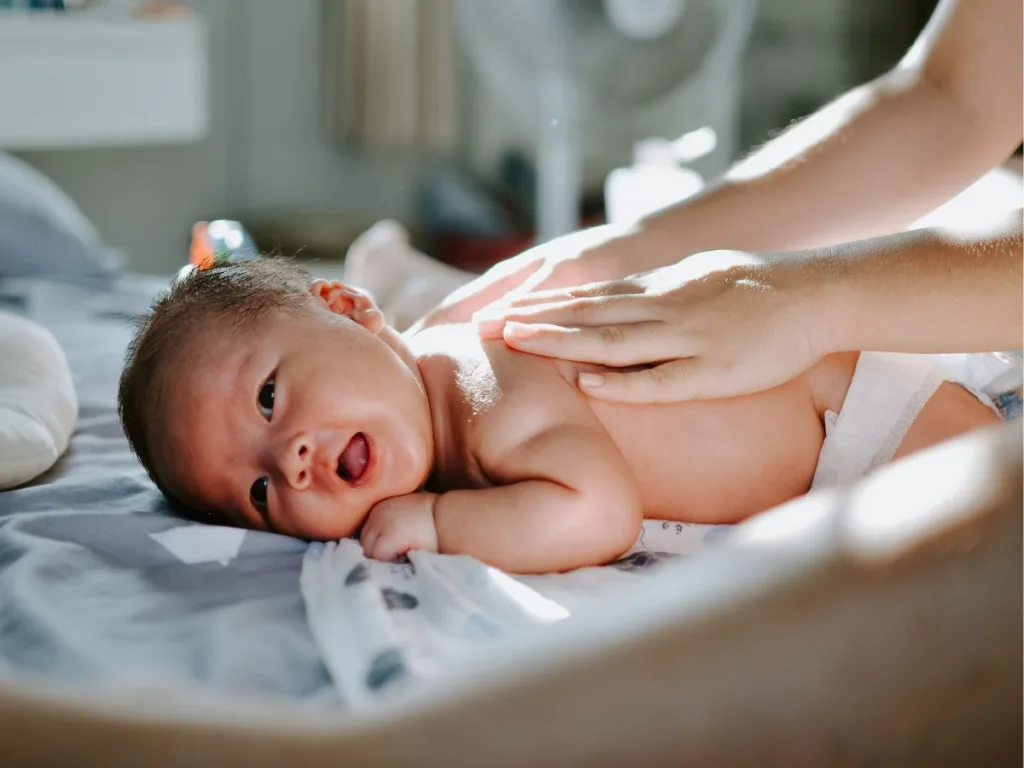 Een baby krijgt een babymassage als kraamcadeau